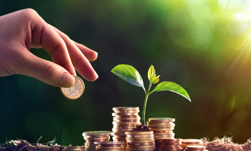 Hand Stacking Coins From Energy Savings